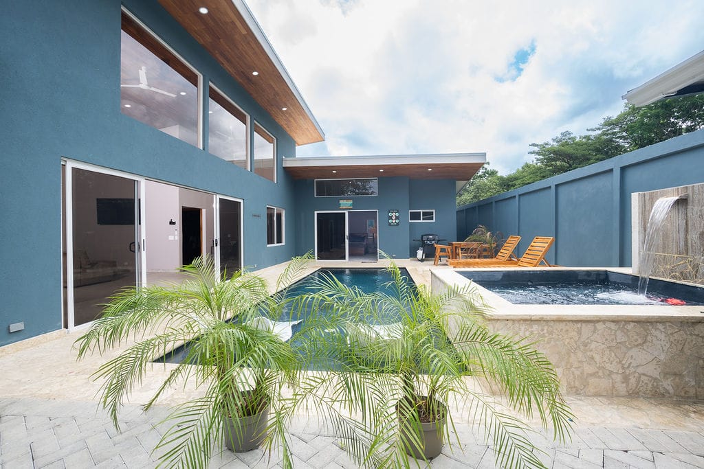 Casa Fenix, pool view with plants in front of the pool under the clear Guanacaste sky