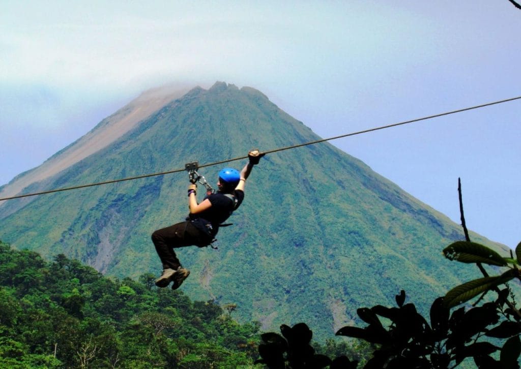 Ziplining adventure in the jungles of Guanacaste, Costa Rica with Arenal Volcano in the background