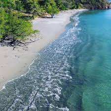 Playa Pan de Azucar, Guanacaste, Costa Rica. Calm crystal clear waters with waves on the sands of the beach